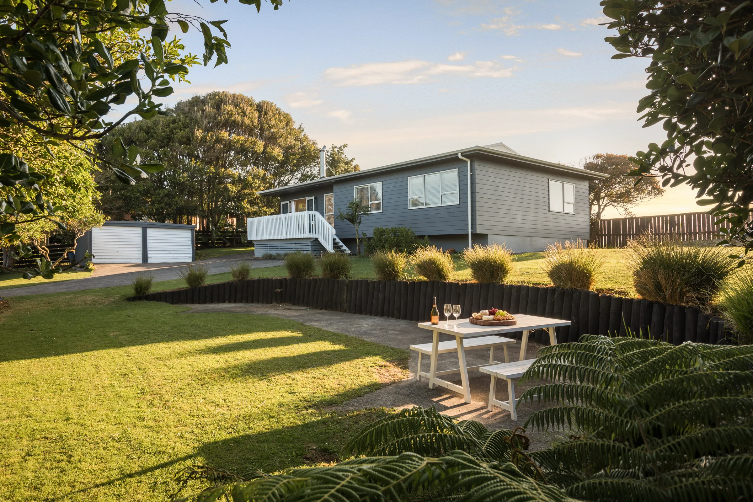 Salt & Citrus framed by native greenery in its Waihi Beach garden.